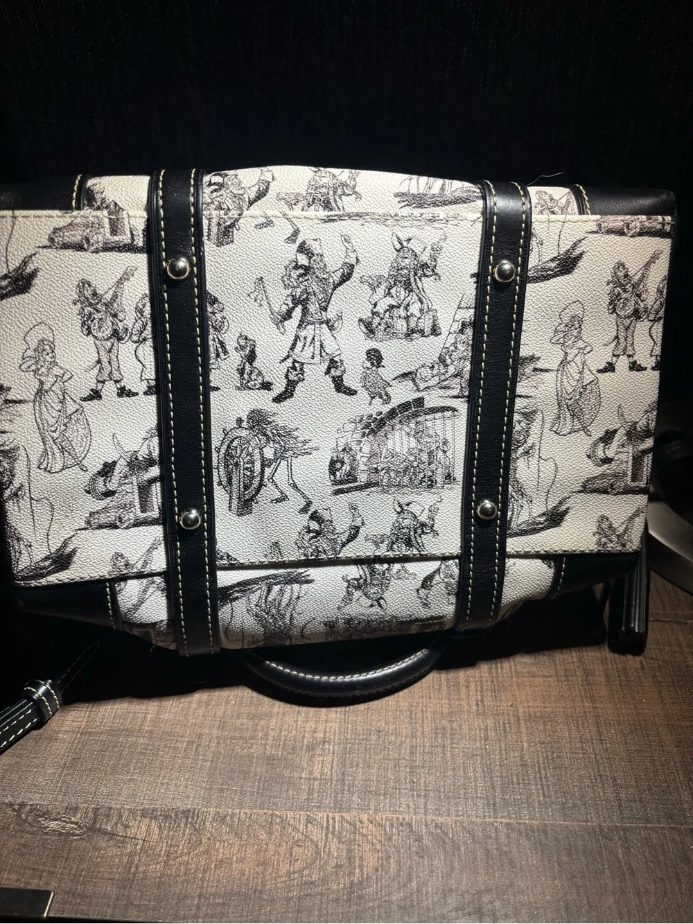 Dooney & Bourke Black and Cream Graphic Satchel with shoulder strap included.